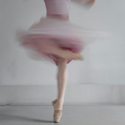 Blurred motion of a person performing a dynamic stretch.