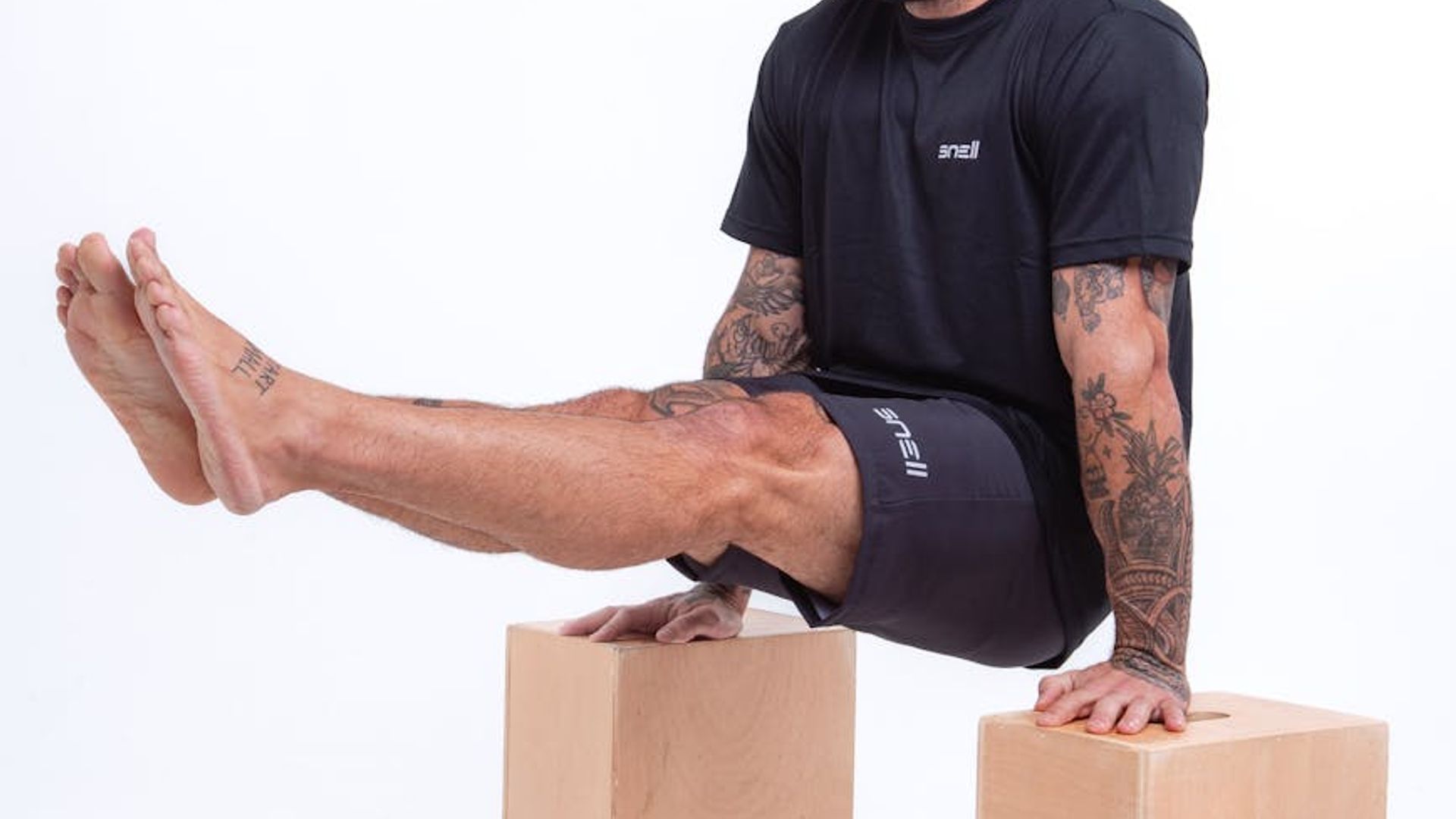Man performing a controlled strength exercise in a minimalist gym.